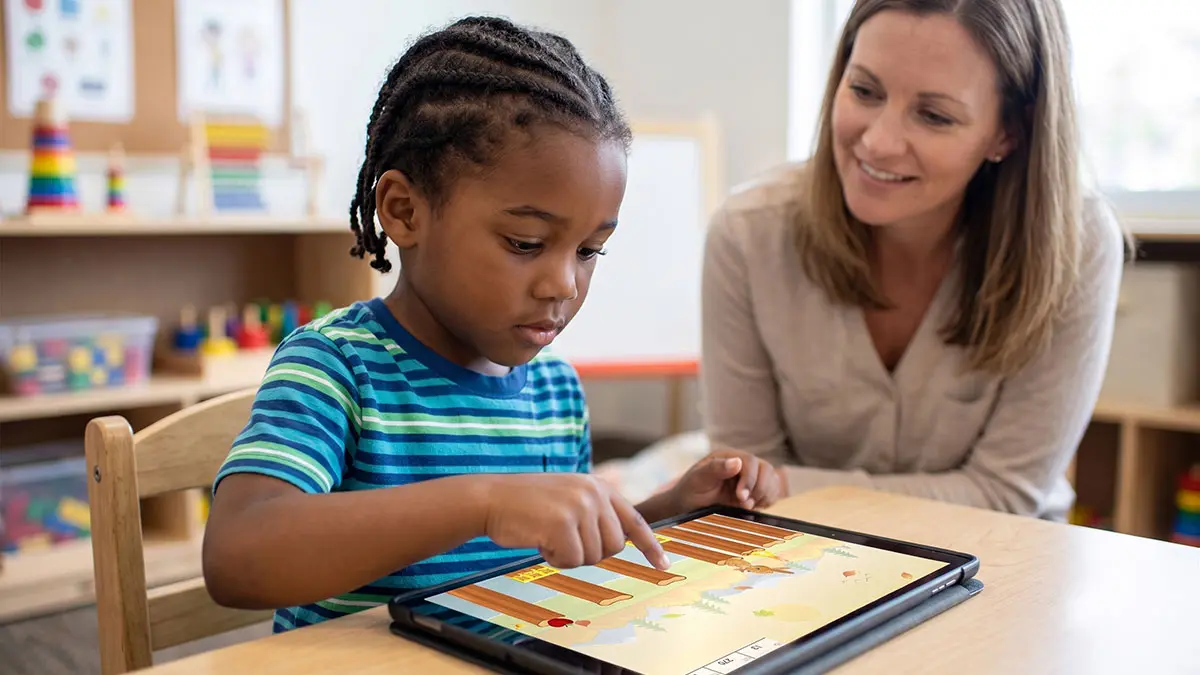 Child demonstrating visual-motor integration by tapping a tablet screen with precise timing